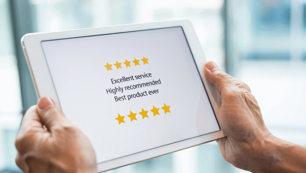 Hands holding tablet displaying five-star customer reviews with excellent service feedback showing successful reputation management results
